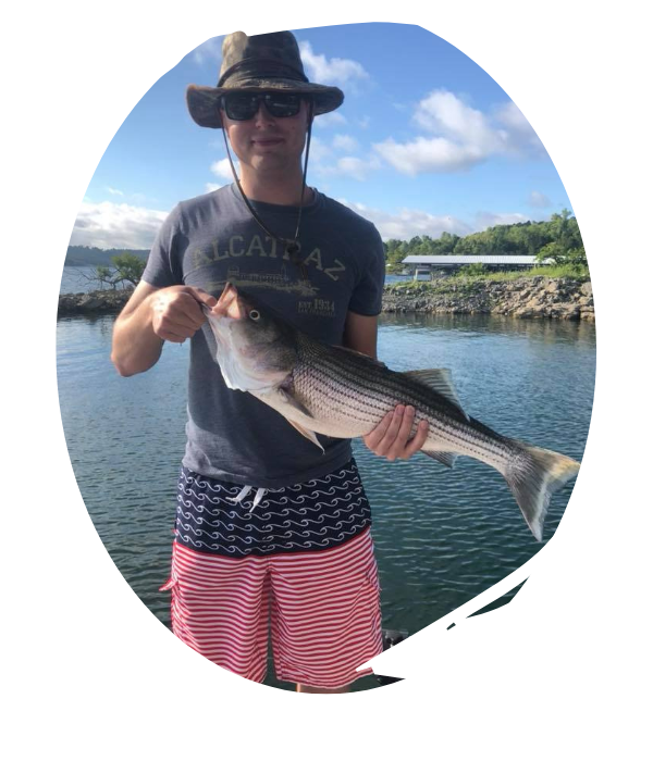 fisherman holding large striper